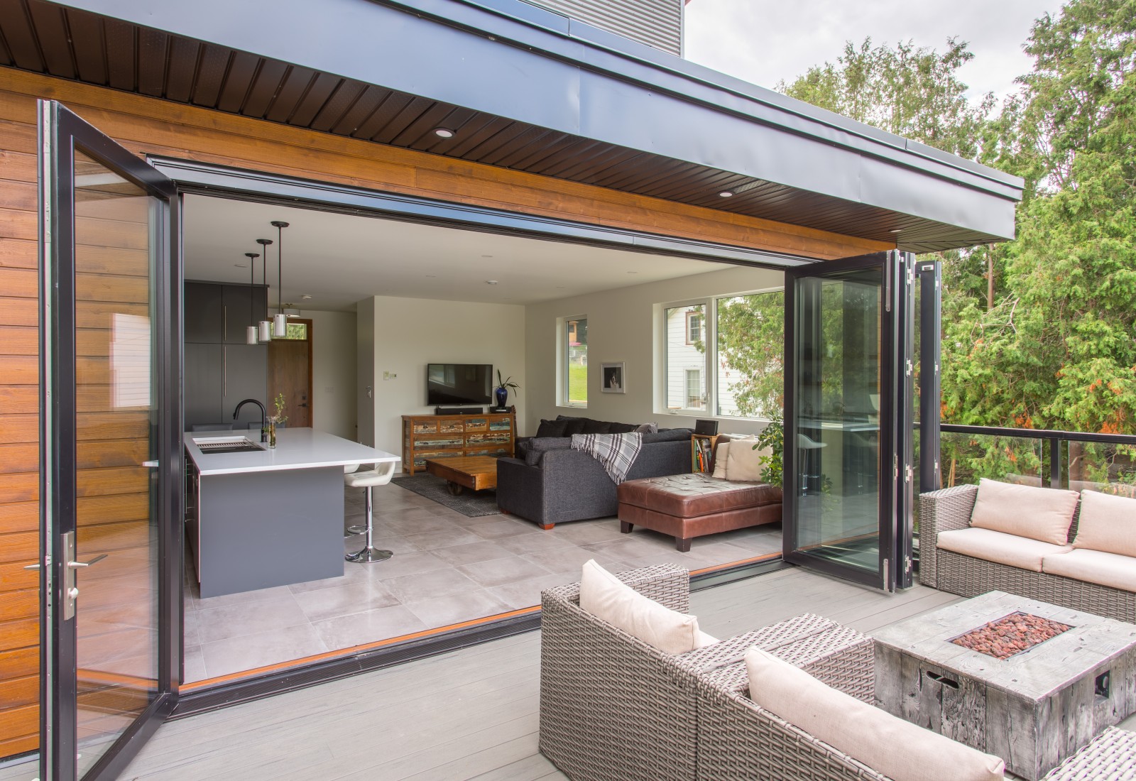Bi-Fold glass doors allow the conversation to easily be carried from the main floor out to the patio